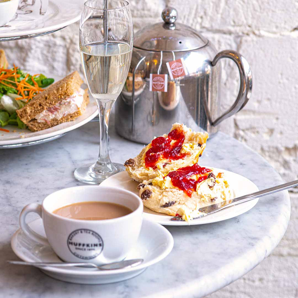 Afternoon tea with scones, prosecco and cup of tea