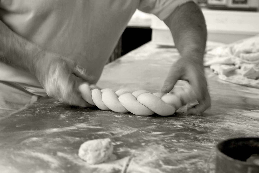 Bakers hands braiding dough