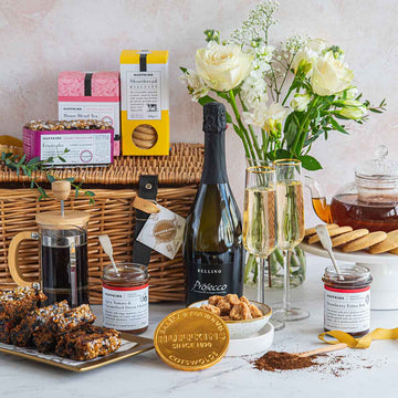 Celebration hamper gift basket with Prosecco, fruitcake, preserves, fudge, biscuits, tea, coffee and a chocolate coin