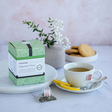 Box of Peppermint Tisane Pyramid Tea Bags and a cup of tea with lemon slices