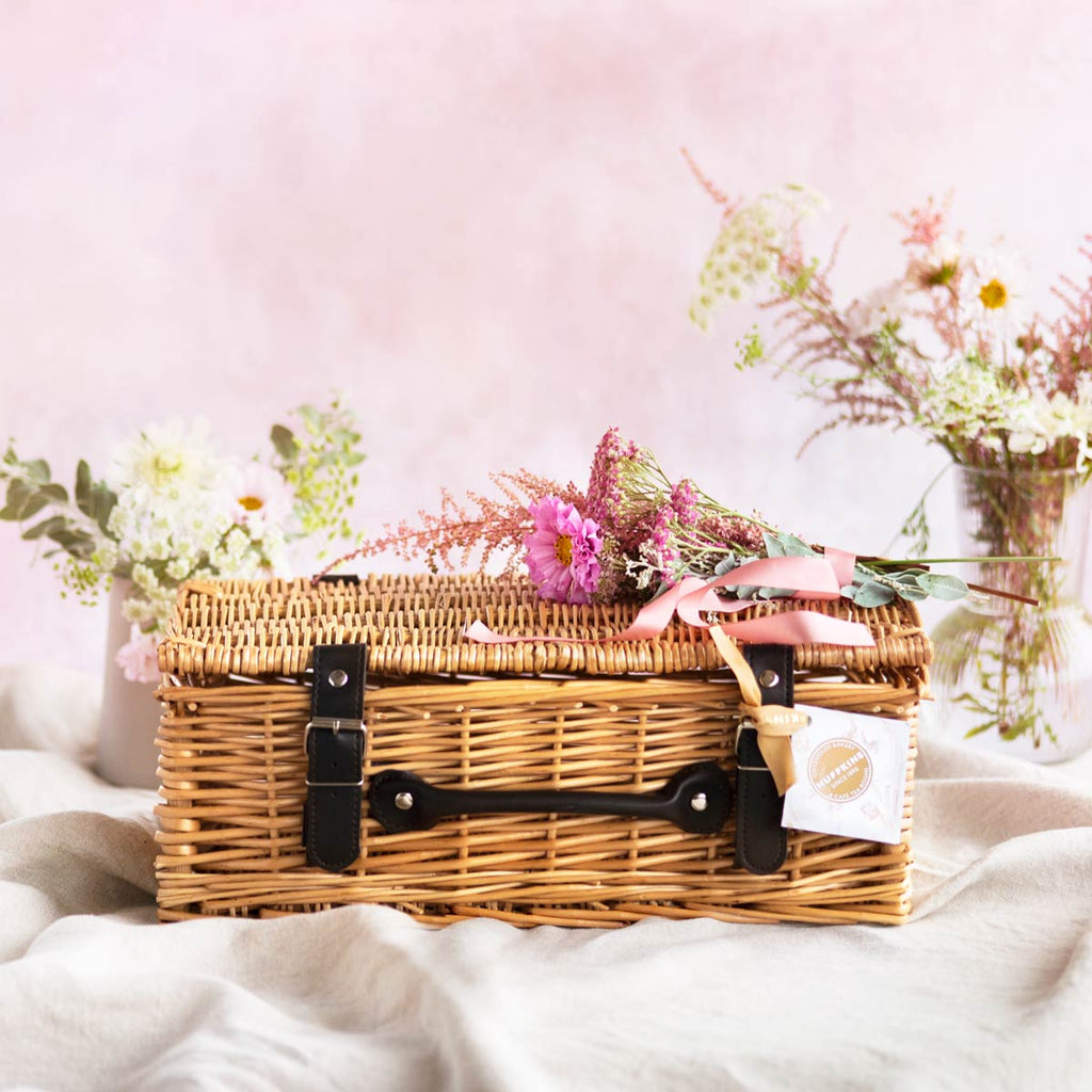 Sustainable wicker hamper basket with faux leather straps